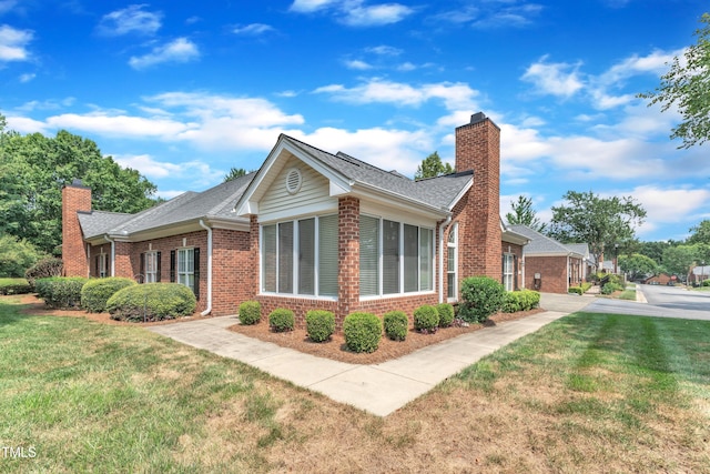 4622 Ludwell Branch Ct, Raleigh, NC 27612 - view of side of property with a chimney, brick siding, and a yard