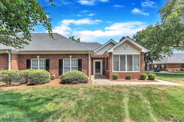 4622 Ludwell Branch Ct, Raleigh, NC 27612 - view of front of house with brick siding, a front lawn, and a shingled roof
