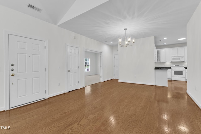 4622 Ludwell Branch Ct, Raleigh, NC 27612 - unfurnished living room with a chandelier, wood finished floors, and recessed lighting