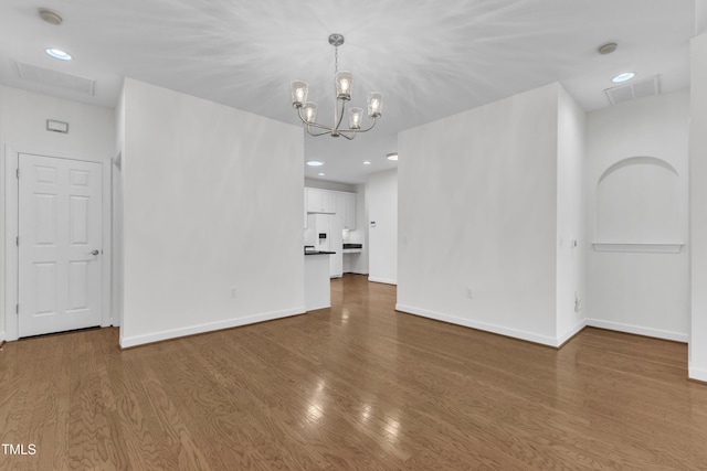 4622 Ludwell Branch Ct, Raleigh, NC 27612 - empty room with wood finished floors, a chandelier, a smoke detector, and recessed lighting