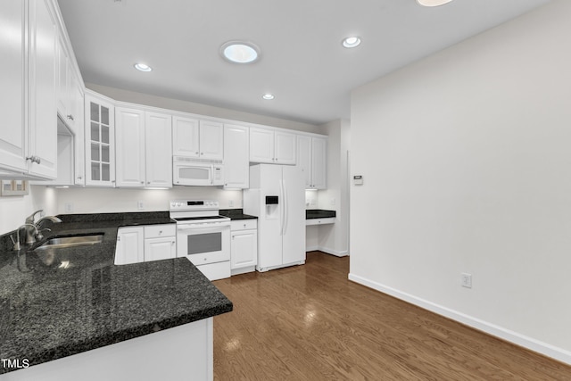 4622 Ludwell Branch Ct, Raleigh, NC 27612 - kitchen with white appliances, white cabinets, recessed lighting, dark wood-style flooring, and glass insert cabinets