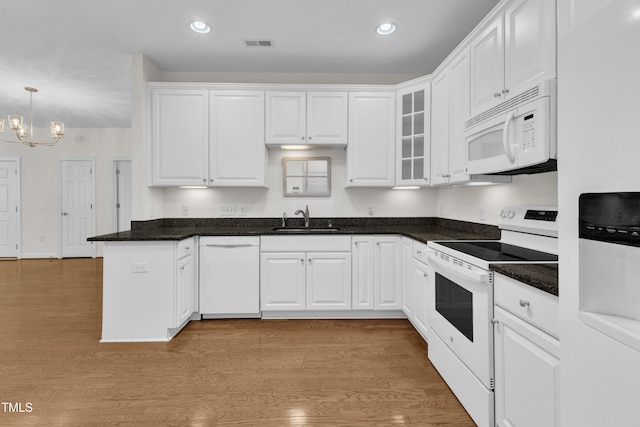 4622 Ludwell Branch Ct, Raleigh, NC 27612 - kitchen with white appliances, white cabinetry, recessed lighting, a chandelier, and a peninsula