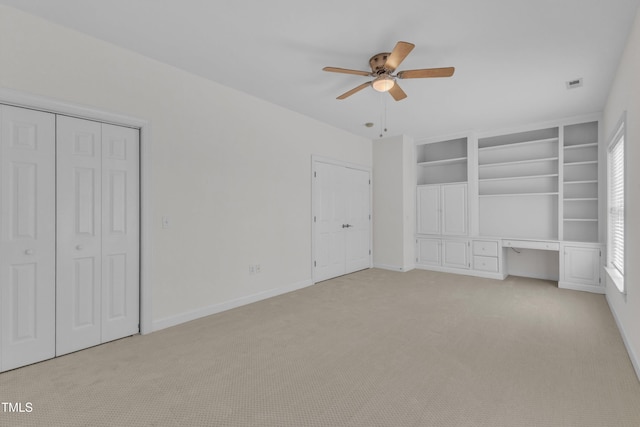 4622 Ludwell Branch Ct, Raleigh, NC 27612 - unfurnished bedroom with light colored carpet, built in study area, and ceiling fan