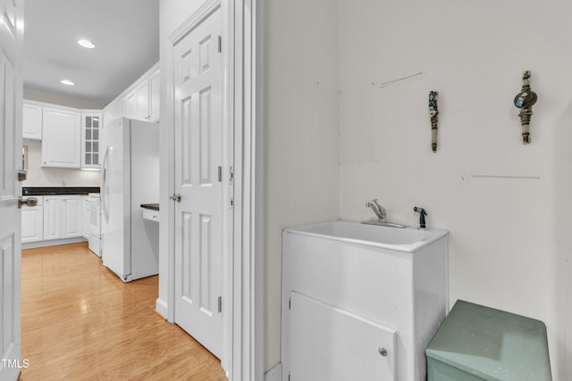 4622 Ludwell Branch Ct, Raleigh, NC 27612 - laundry room featuring light wood-style floors and recessed lighting