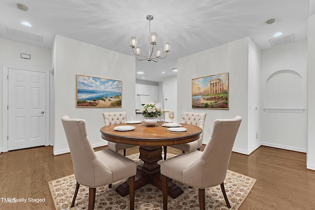4622 Ludwell Branch Ct, Raleigh, NC 27612 - dining space with wood finished floors, a chandelier, and recessed lighting