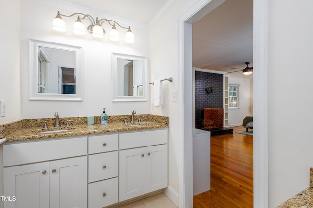 256 Marilyn Cir, Cary, NC 27513 - full bathroom with ornamental molding, double vanity, ceiling fan, a fireplace, and wood finished floors