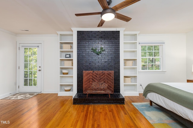 256 Marilyn Cir, Cary, NC 27513 - bedroom featuring wood finished floors, multiple windows, a fireplace, access to outside, and ornamental molding
