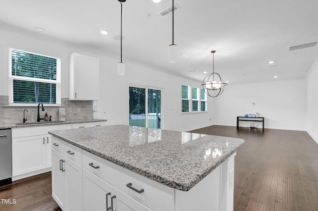 1505 Willow Landing Way, Willow Springs, NC 27592 - kitchen with a center island, decorative backsplash, light stone counters, dark wood-type flooring, and recessed lighting