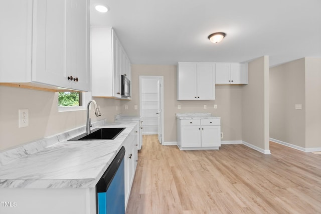 810 Williams St, Burlington, NC 27217 - kitchen featuring dishwashing machine, light wood-style flooring, white cabinetry, and stainless steel microwave