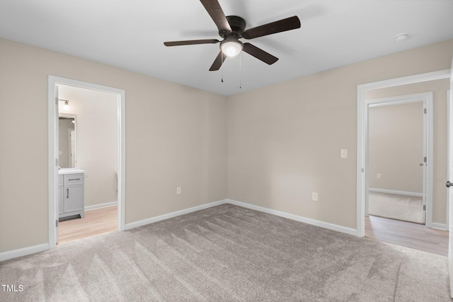 810 Williams St, Burlington, NC 27217 - unfurnished bedroom featuring light colored carpet, connected bathroom, and a ceiling fan