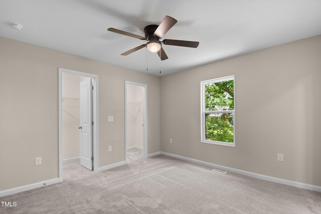 810 Williams St, Burlington, NC 27217 - unfurnished bedroom featuring a spacious closet, a closet, light carpet, and ceiling fan