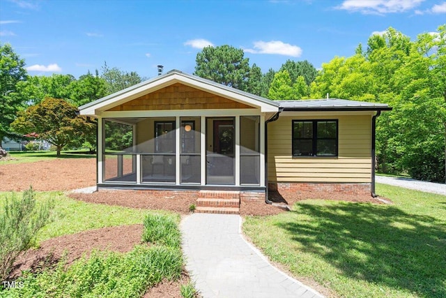 3213 Mid Pines Rd, Raleigh, NC 27606 - view of front of house with a sunroom and a front lawn