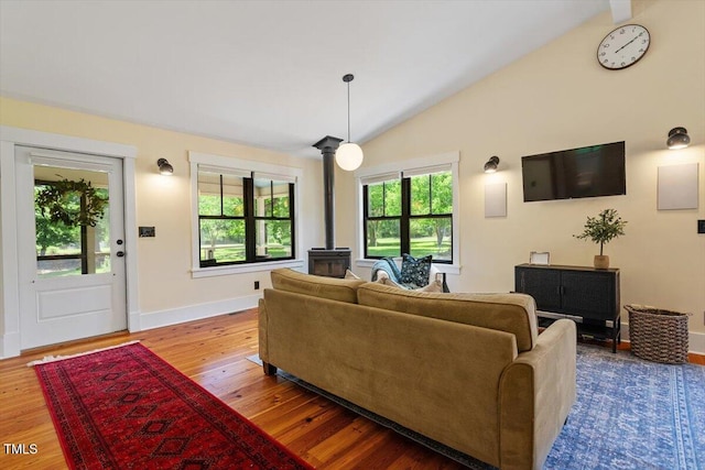 3213 Mid Pines Rd, Raleigh, NC 27606 - living area featuring a wood stove, vaulted ceiling, and wood finished floors