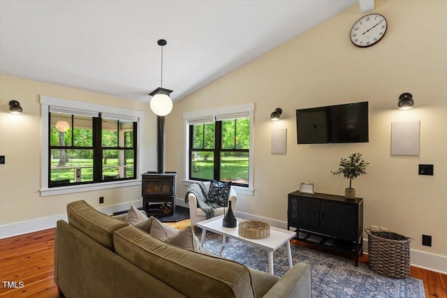 3213 Mid Pines Rd, Raleigh, NC 27606 - living room featuring a wood stove, lofted ceiling, and wood finished floors