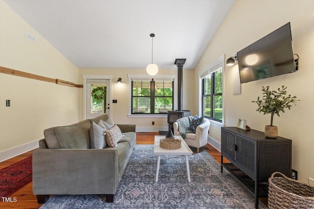 3213 Mid Pines Rd, Raleigh, NC 27606 - living area featuring lofted ceiling, wood finished floors, and a wood stove