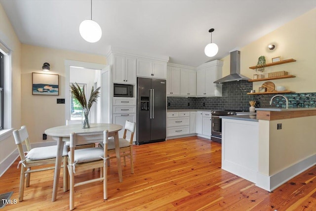 3213 Mid Pines Rd, Raleigh, NC 27606 - kitchen featuring high quality fridge, stainless steel range with electric stovetop, black microwave, wall chimney exhaust hood, and tasteful backsplash