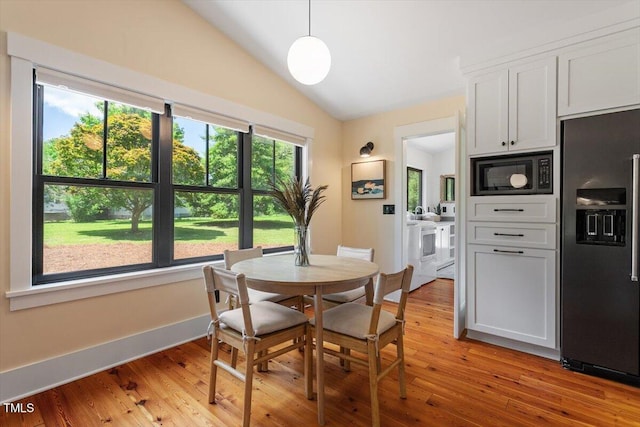 3213 Mid Pines Rd, Raleigh, NC 27606 - dining area featuring separate washer and dryer, vaulted ceiling, and light wood-style floors