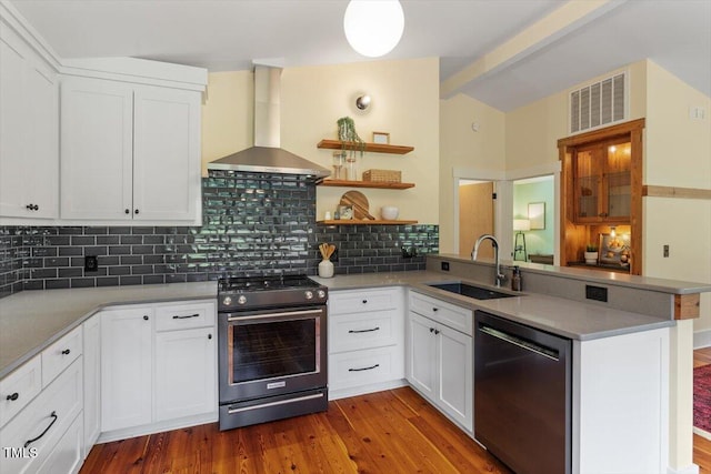 3213 Mid Pines Rd, Raleigh, NC 27606 - kitchen featuring dishwashing machine, stainless steel range with gas cooktop, wall chimney exhaust hood, a peninsula, and tasteful backsplash