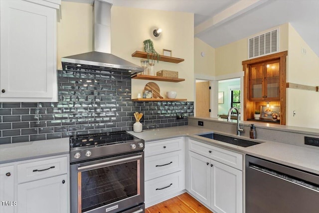 3213 Mid Pines Rd, Raleigh, NC 27606 - kitchen with stainless steel range, dishwasher, wall chimney range hood, white cabinets, and tasteful backsplash