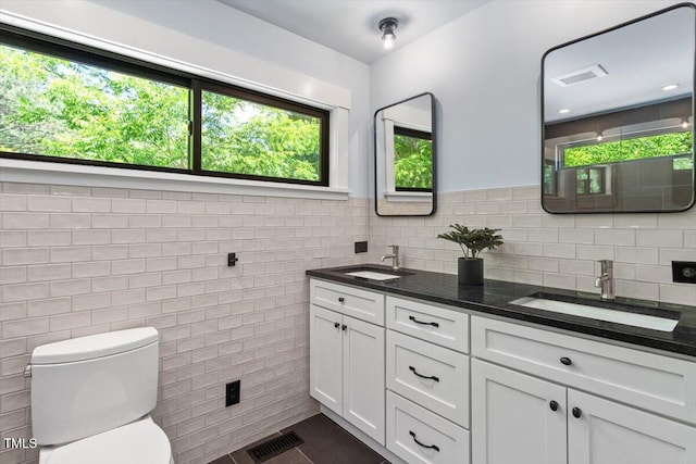 3213 Mid Pines Rd, Raleigh, NC 27606 - bathroom with double vanity and tile walls