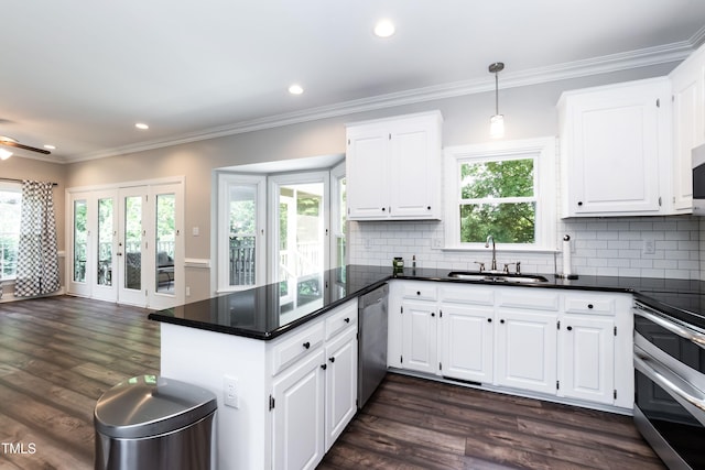 6205 Remington Lake Dr, Raleigh, NC 27616 - kitchen with appliances with stainless steel finishes, a peninsula, dark countertops, white cabinetry, and recessed lighting