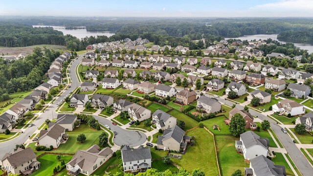 184 Elgin Ct, Burlington, NC 27215 - aerial perspective of suburban area with a large body of water and a heavily wooded area