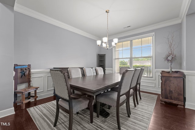184 Elgin Ct, Burlington, NC 27215 - dining area featuring a chandelier, crown molding, a wainscoted wall, wood finished floors, and a decorative wall