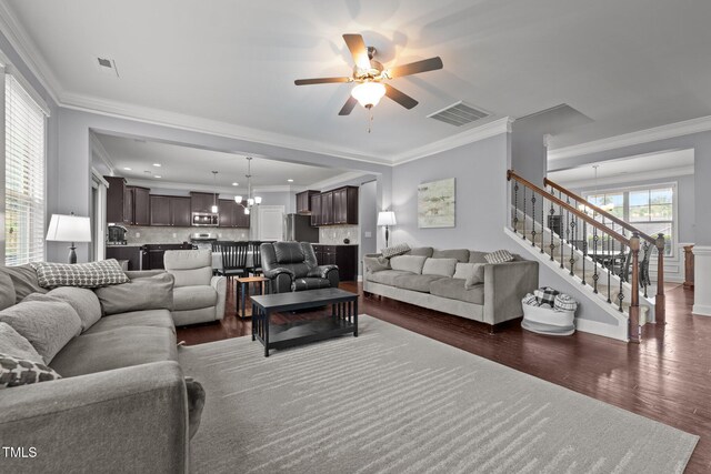 184 Elgin Ct, Burlington, NC 27215 - living room with dark wood finished floors, ceiling fan, crown molding, stairway, and a chandelier