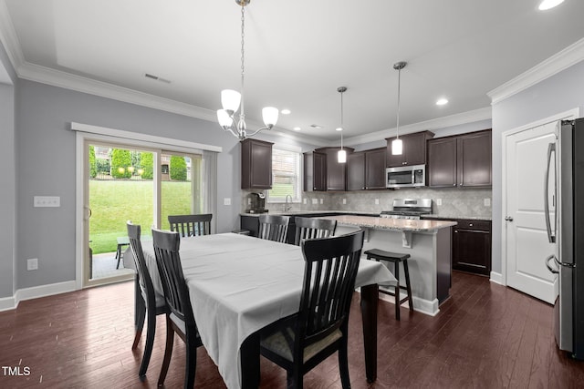 184 Elgin Ct, Burlington, NC 27215 - dining space featuring ornamental molding, dark wood-style floors, recessed lighting, and a chandelier