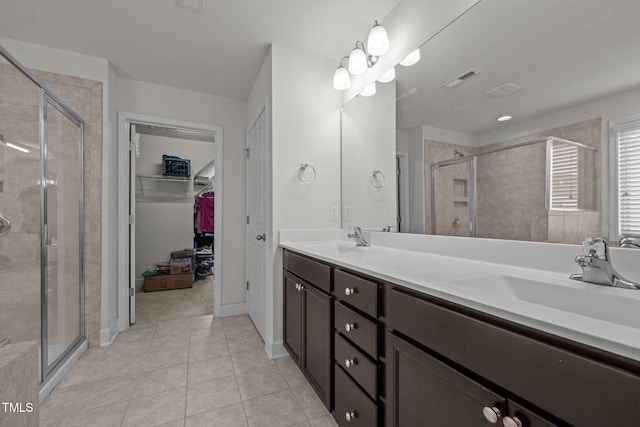 184 Elgin Ct, Burlington, NC 27215 - full bathroom featuring a stall shower, double vanity, a spacious closet, and tile patterned floors