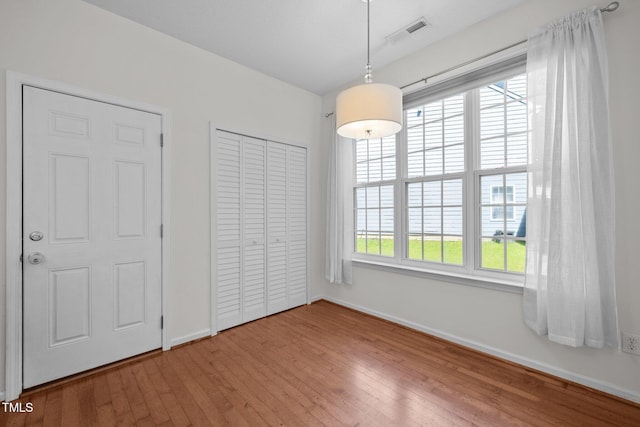 110 Bonhill Ct, Apex, NC 27502 - unfurnished dining area featuring baseboards and wood-type flooring