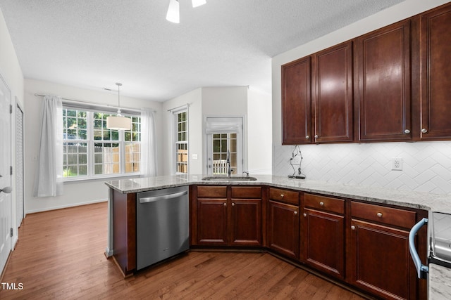 110 Bonhill Ct, Apex, NC 27502 - kitchen with dishwasher, a peninsula, wood finished floors, backsplash, and light stone countertops