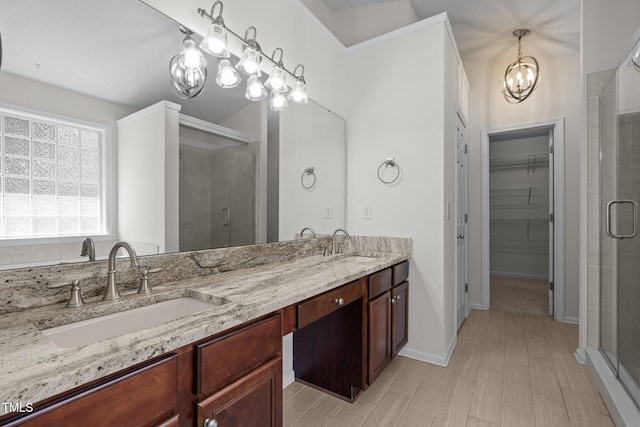 110 Bonhill Ct, Apex, NC 27502 - full bathroom with a chandelier, a stall shower, double vanity, and a spacious closet