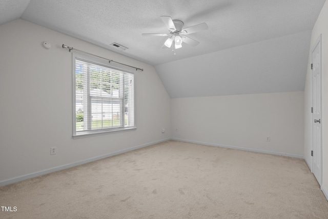 110 Bonhill Ct, Apex, NC 27502 - bonus room featuring vaulted ceiling, a ceiling fan, light colored carpet, and a textured ceiling