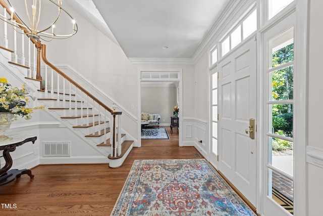1105 Tazwell Pl, Raleigh, NC 27612 - entryway with stairs, a decorative wall, wood finished floors, ornamental molding, and a wainscoted wall