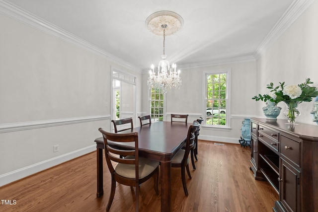 1105 Tazwell Pl, Raleigh, NC 27612 - dining space with a chandelier, ornamental molding, dark wood-type flooring, and wainscoting