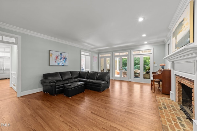 1105 Tazwell Pl, Raleigh, NC 27612 - living room featuring a brick fireplace, crown molding, recessed lighting, and light wood-type flooring