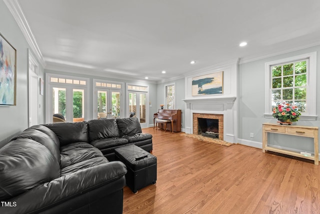 1105 Tazwell Pl, Raleigh, NC 27612 - living area with ornamental molding, healthy amount of natural light, a brick fireplace, light wood-style floors, and recessed lighting