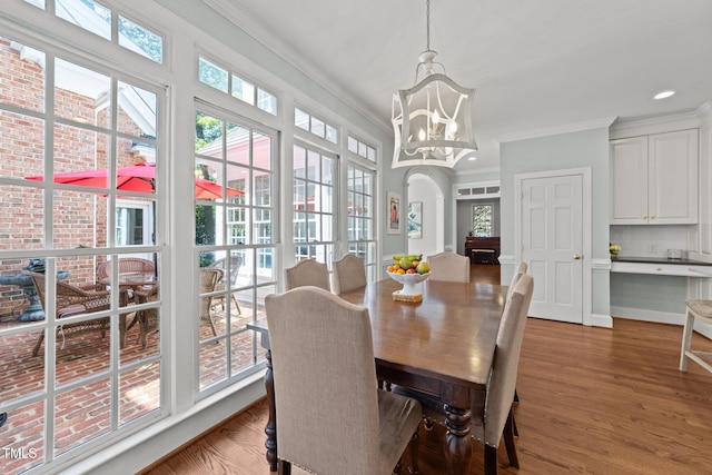 1105 Tazwell Pl, Raleigh, NC 27612 - dining area featuring ornamental molding, a chandelier, recessed lighting, and wood finished floors