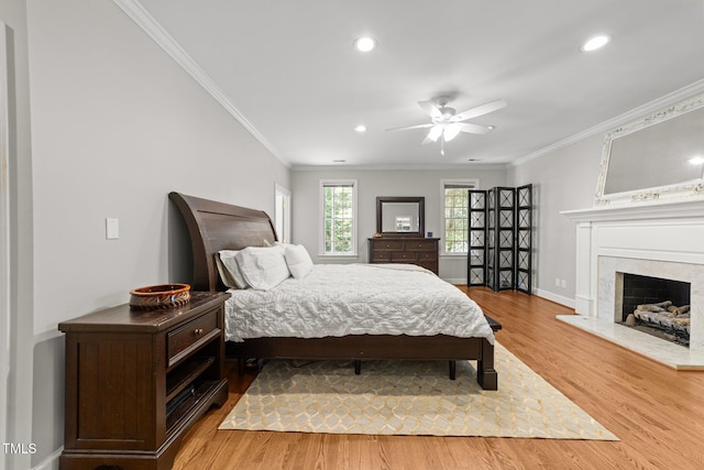 1105 Tazwell Pl, Raleigh, NC 27612 - bedroom with crown molding, wood finished floors, recessed lighting, a fireplace, and ceiling fan