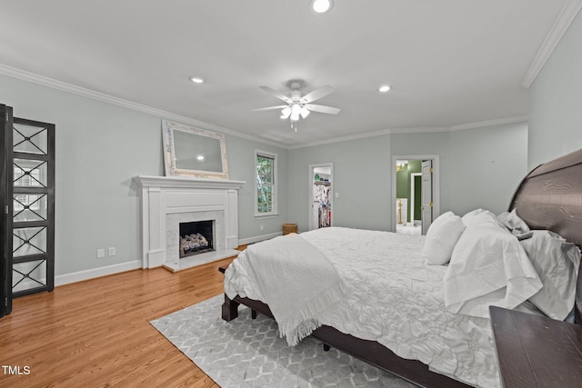1105 Tazwell Pl, Raleigh, NC 27612 - bedroom featuring wood finished floors, recessed lighting, crown molding, a high end fireplace, and ceiling fan