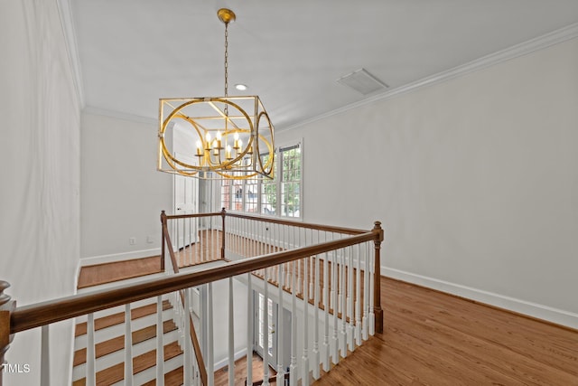 1105 Tazwell Pl, Raleigh, NC 27612 - stairs featuring crown molding, a chandelier, and wood finished floors
