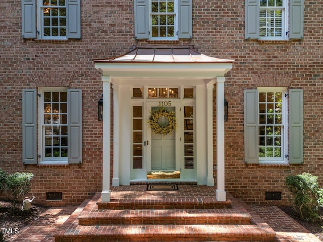 1105 Tazwell Pl, Raleigh, NC 27612 - entrance to property with crawl space, brick siding, and a standing seam roof
