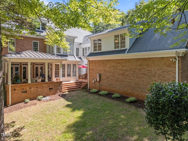 1105 Tazwell Pl, Raleigh, NC 27612 - back of house featuring a yard, brick siding, and roof with shingles