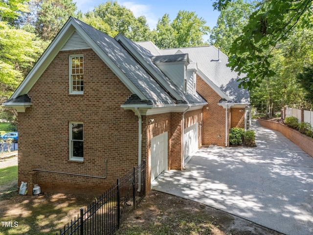 1105 Tazwell Pl, Raleigh, NC 27612 - view of front of house featuring driveway, an attached garage, and brick siding