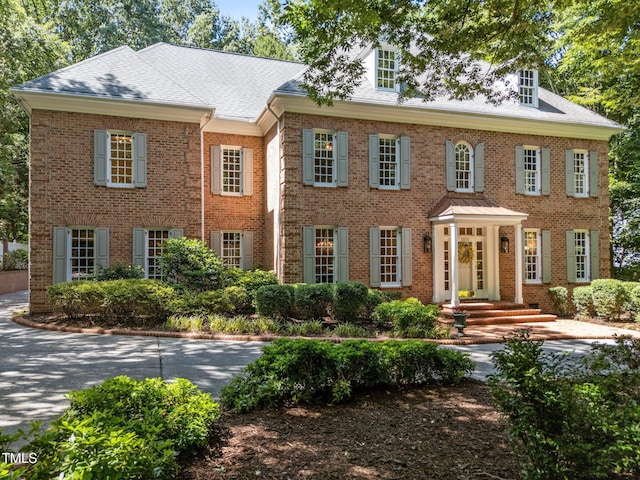 1105 Tazwell Pl, Raleigh, NC 27612 - colonial inspired home with brick siding and a shingled roof