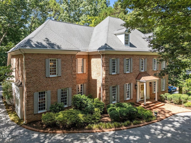 1105 Tazwell Pl, Raleigh, NC 27612 - colonial-style house featuring brick siding and roof with shingles
