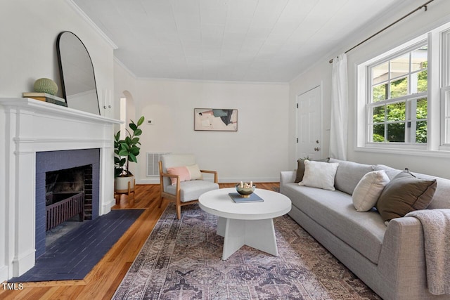 2504 State St, Durham, NC 27704 - living area featuring ornamental molding, wood finished floors, and a brick fireplace