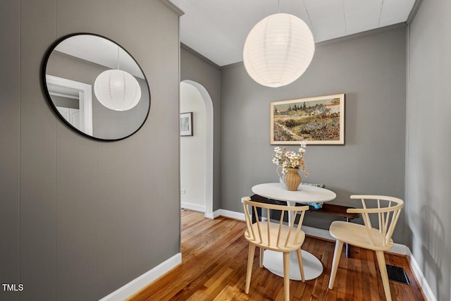2504 State St, Durham, NC 27704 - dining area featuring arched walkways, crown molding, and wood finished floors