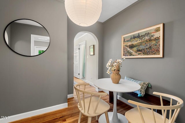 2504 State St, Durham, NC 27704 - dining space with arched walkways, wood finished floors, and crown molding